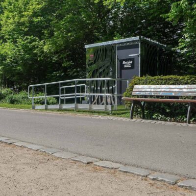 Außenansicht der Libre-DIN Kabine im Ammonpark Eberswalde mit Edelstahlverkleidung und rollstuhlgerechter Zugangsrampe.